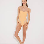"Model wearing the Vivia Orange/Nude Molded Cup Strapless Swimsuit from the front, showcasing the geometric embroidery that contours the figure and the molded cups that offer support and a push-up effect. "
