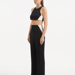 "Model presenting the Wade Black/White Pants from the side, emphasizing the flattering high-waist silhouette and the elegant flow of the fabric."