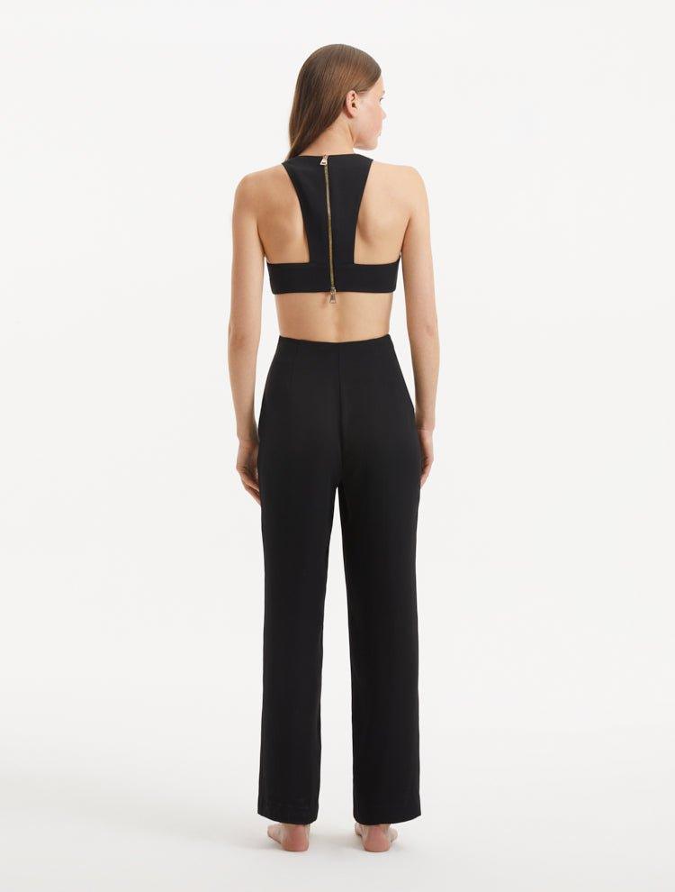 "Model displaying the Wade Black/White Pants from the back, focusing on the sleek high-waist design and the overall streamlined fit of the pants."