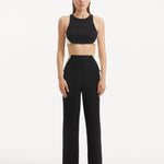 "Model showcasing the Wade Black/White Pants from the front, highlighting the high-waist design and the dynamic black and white color contrast. "