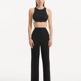 "Model showcasing the Wade Black/White Pants from the front, highlighting the high-waist design and the dynamic black and white color contrast. "