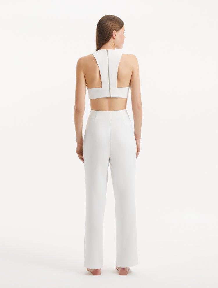 "Model presenting the Wade White/Brown Pants from the back, demonstrating the sleek high-waist silhouette and the overall tailored fit."