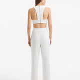 "Model presenting the Wade White/Brown Pants from the back, demonstrating the sleek high-waist silhouette and the overall tailored fit."