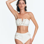 ": Front view of the bandeau Wendy Seersucker bikini top with a notched neckline, golden eyelets, and subtle round hardware details."