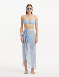 Model wearing the Xander Baby Blue Skort from the front, showcasing the high-rise cut and shell-shaped gold button details.