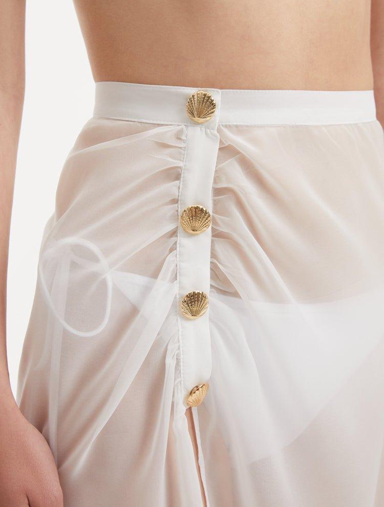 Xander White Sheer Maxi Skirt with Gold Button Details | Moeva | Skirt | Each week unveils new pieces—luxury swimwear, fluid resort silhouettes, and elevated summer-to-evening essentials designed to carry you from coastal escapes to city nights.