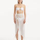 Model wearing the Xander White Skirt from the front, highlighting the high-rise design and shell-shaped gold button details