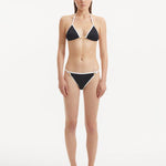 Front view of the Zarya Black Bikini Bottom, showcasing its low-rise cut and duo-colored design.