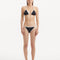 Front view of the Zarya Black Bikini Bottom, showcasing its low-rise cut and duo-colored design.