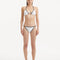Front view of the Zarya White Bikini Bottom, highlighting its low-rise silhouette and duo-colored design.