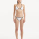 Front view of the Zarya White Bikini Bottom, highlighting its low-rise silhouette and duo-colored design.